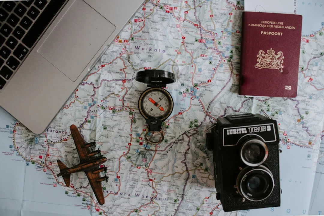 Travel planning materials spread on a wooden table