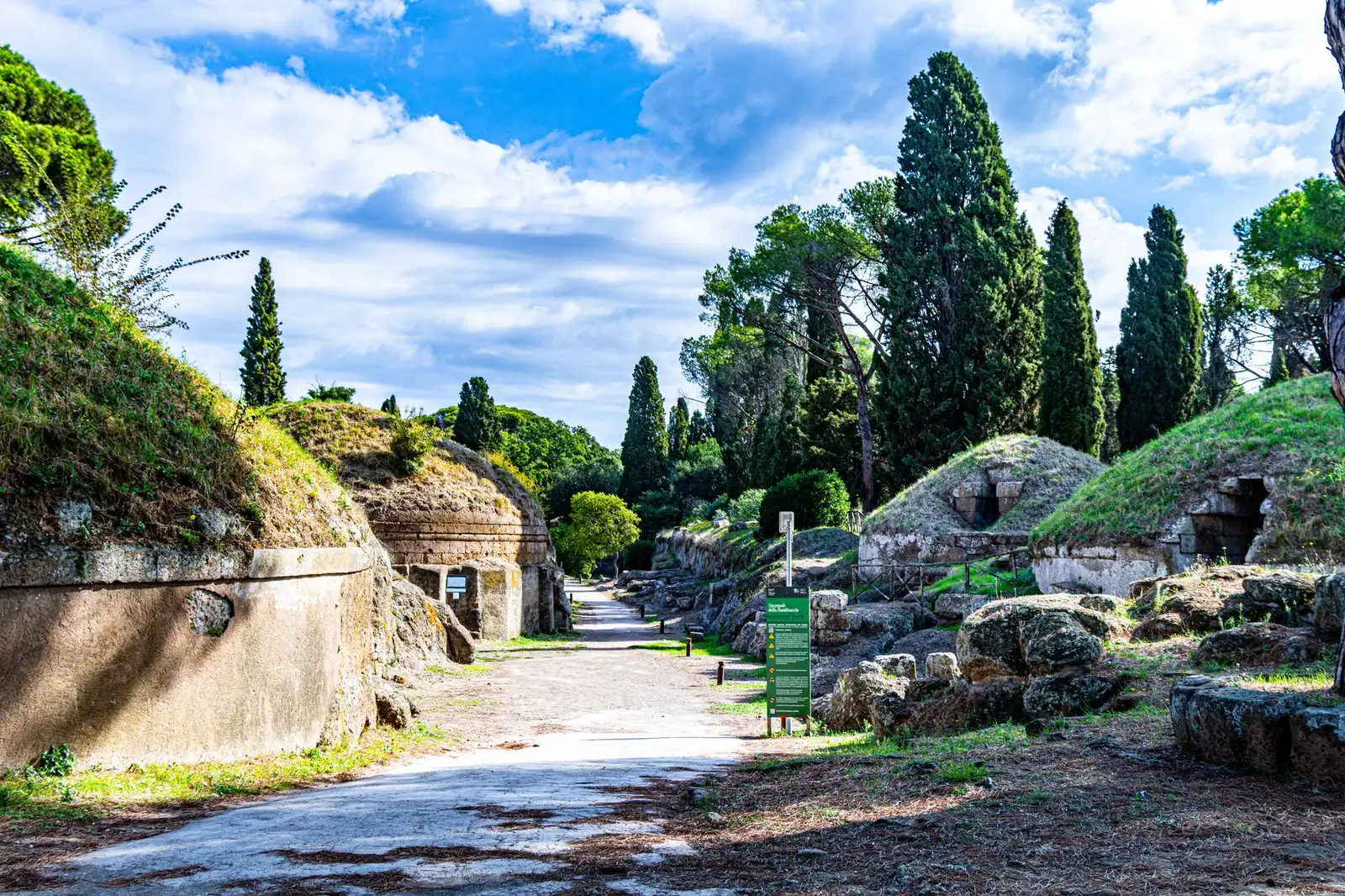 Explore the historic Etruscan tombs at Cerveteri Necropolis in Lazio, Italy, surrounded by lush greenery.